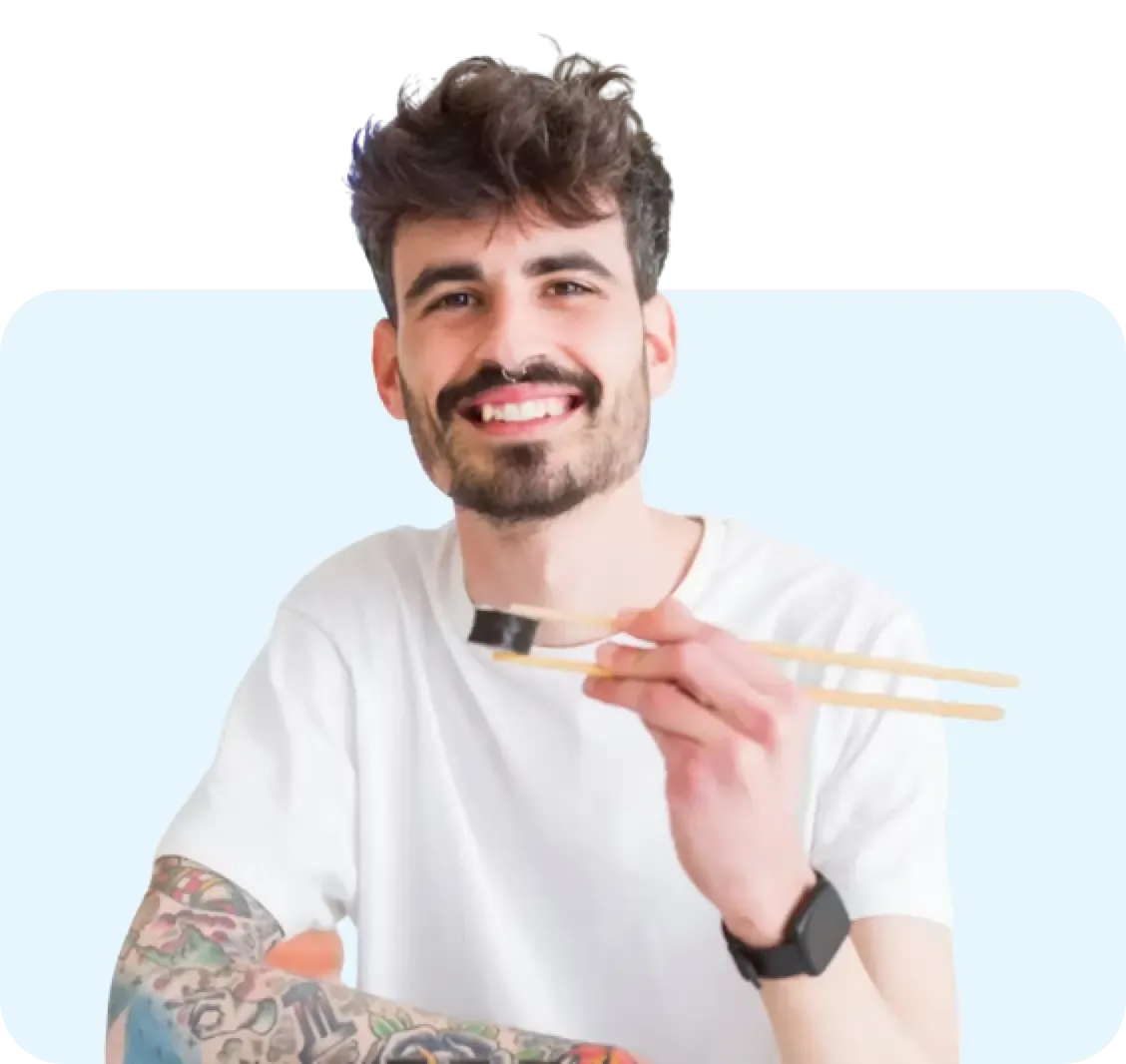 Man smilling while eating sushi